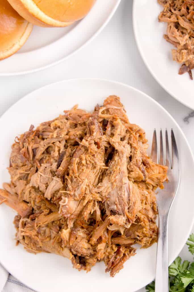 slow cooker pulled pork in a white bowl 