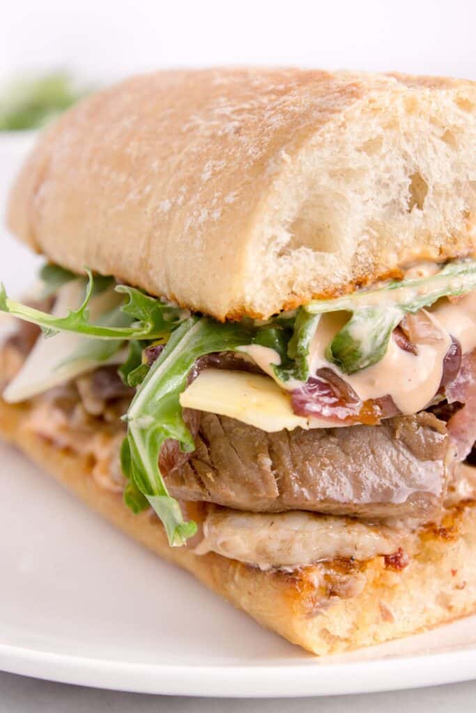 close up of easy steak sandwich recipe on a white plate
