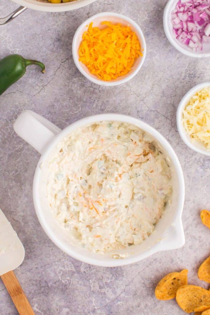 Corn dip being mixed together in a mixing bowl