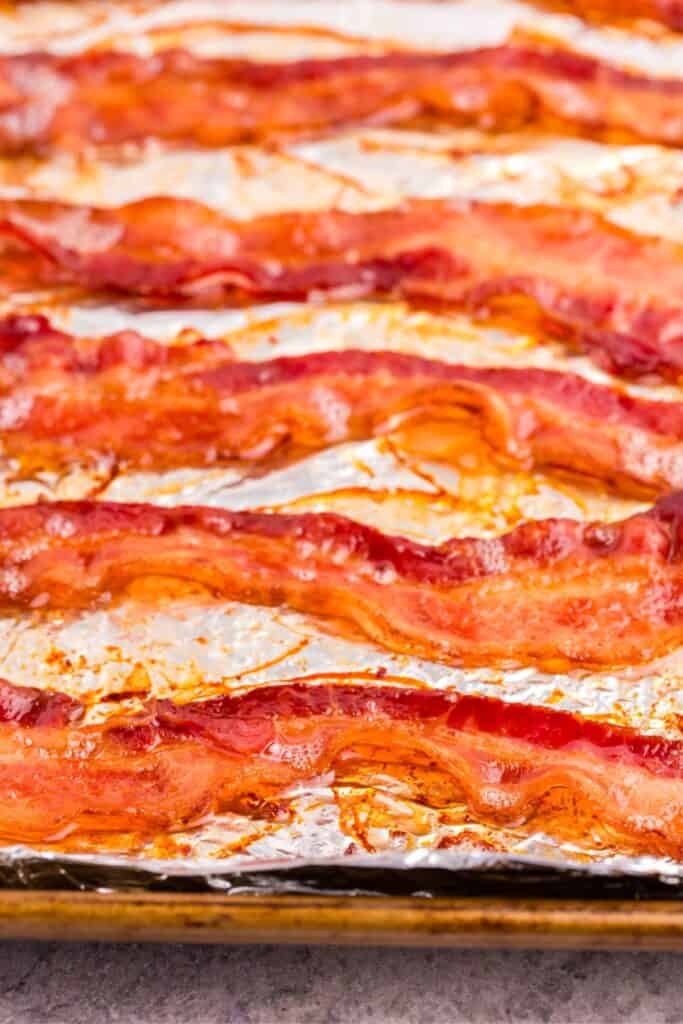 baked bacon on a baking sheet covered in aluminum foil.