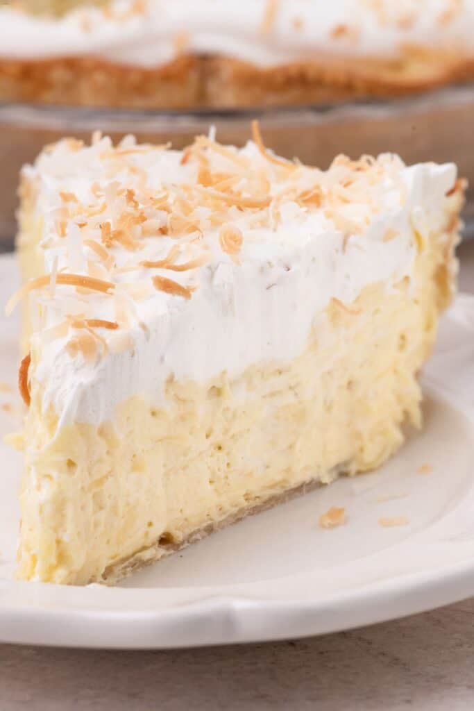 Close up image of a slice of coconut cream pie.