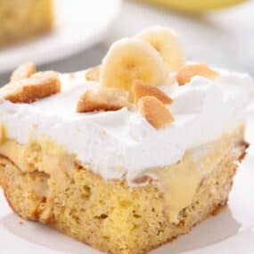 Slice of banana pudding cake on a white plate.