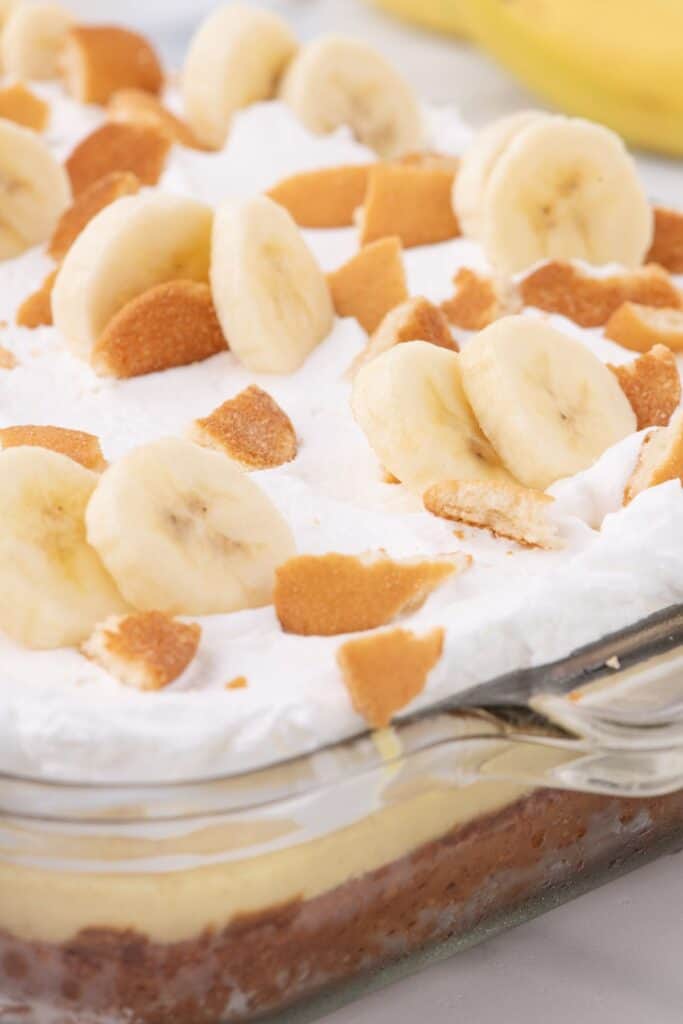 Close up of banana pudding cake in a glass baking dish.