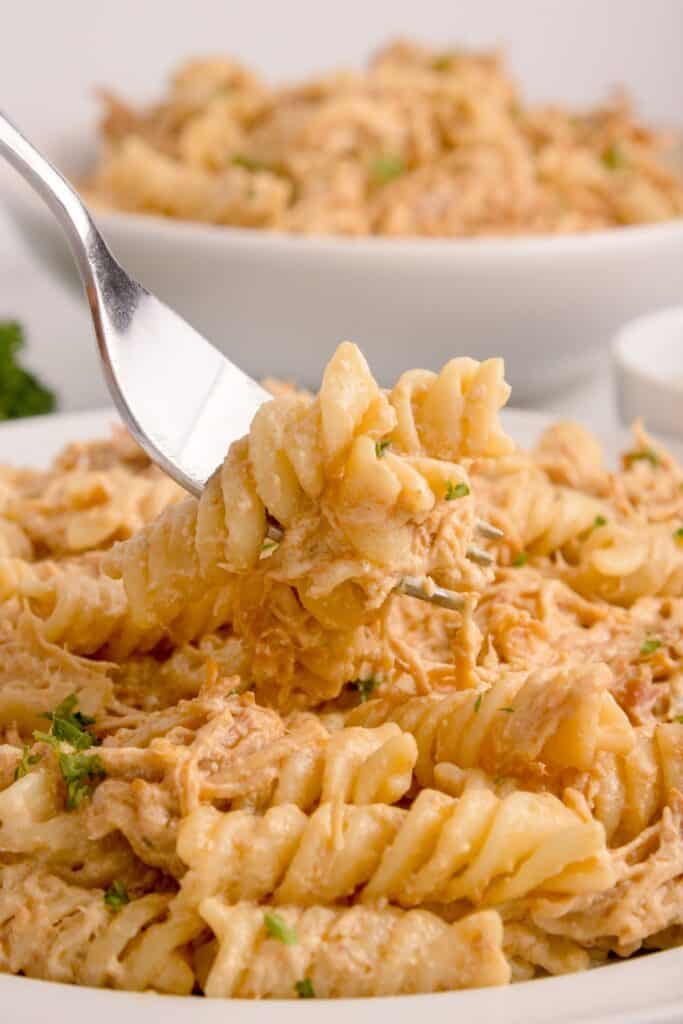 Large serving of Garlic Parmesan Chicken and Pasta on a white plate with a fork.