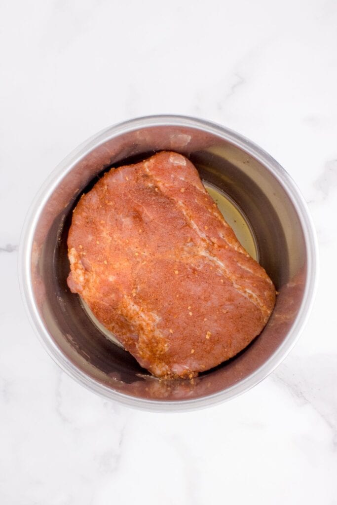 Overhead image of uncooked pork loin in Instant Pot.