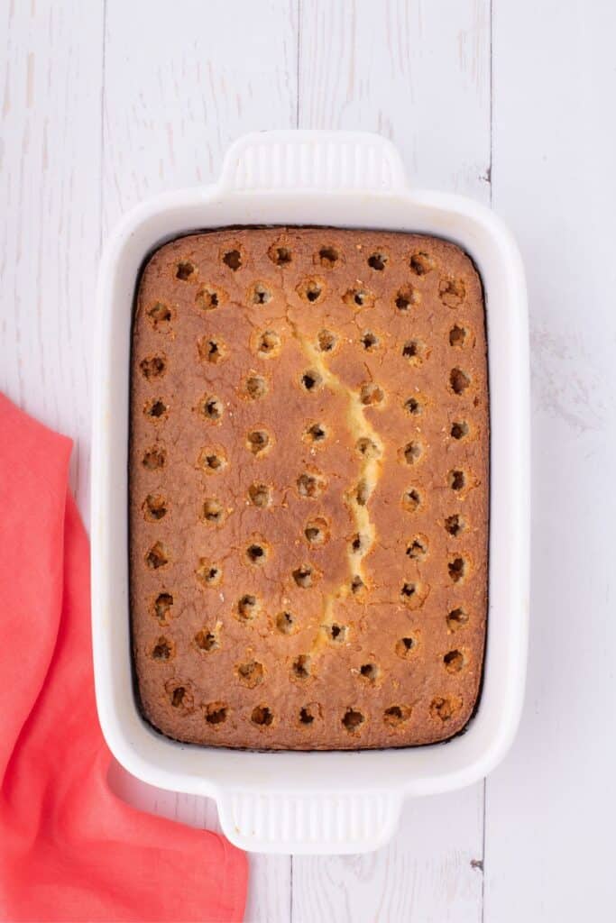 Baked white cake mix before adding strawberry jello over the top.