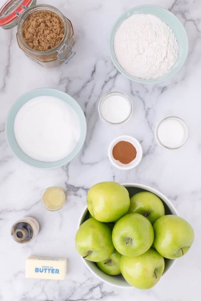 Ingredients for apple cobbler: Granny Smith apples, lemon juice, sugar, brown sugar, flour, cinnamon, salt, vanilla, butter, baking powder