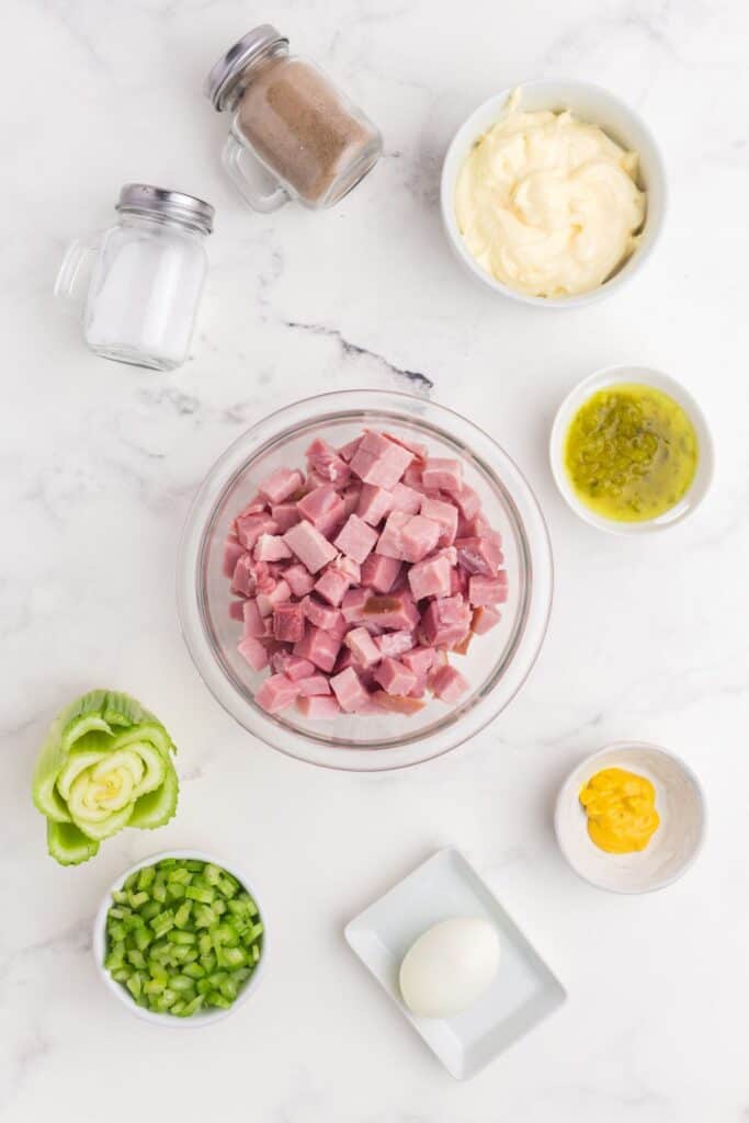 Ingredients for ham salad: ham, celery, hard boiled egg, mayo, sweet relish, and yellow mustard.