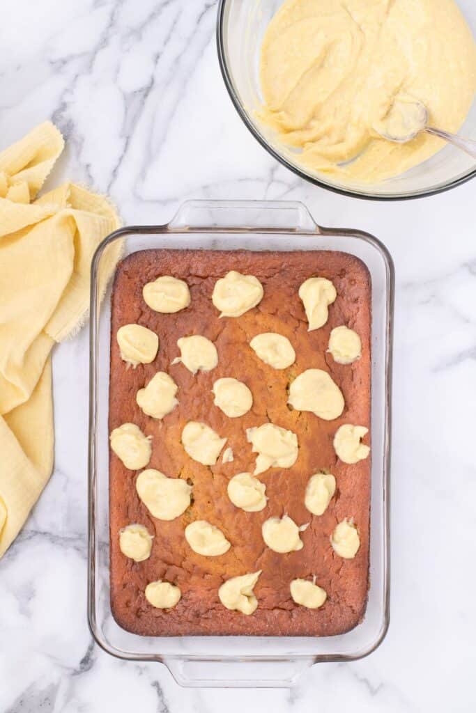 banana pudding cake cooked with holes filled with banana pudding.