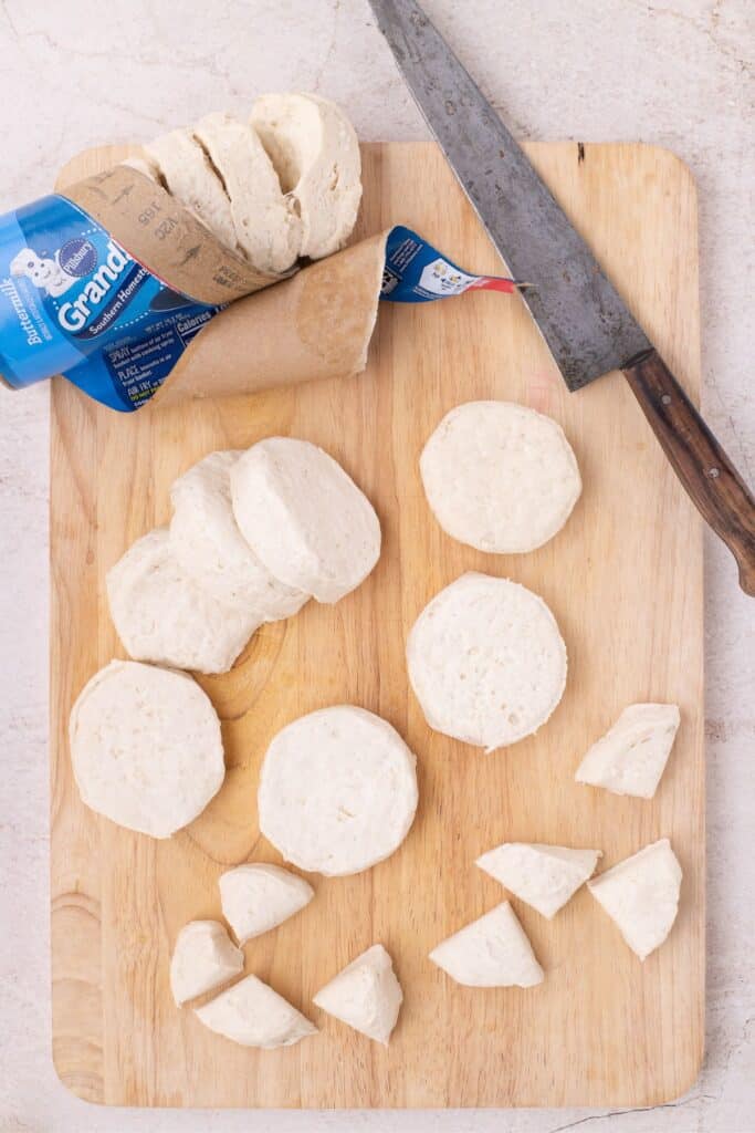 Refrigerated biscuits removed from packaging and chopped into quarters.