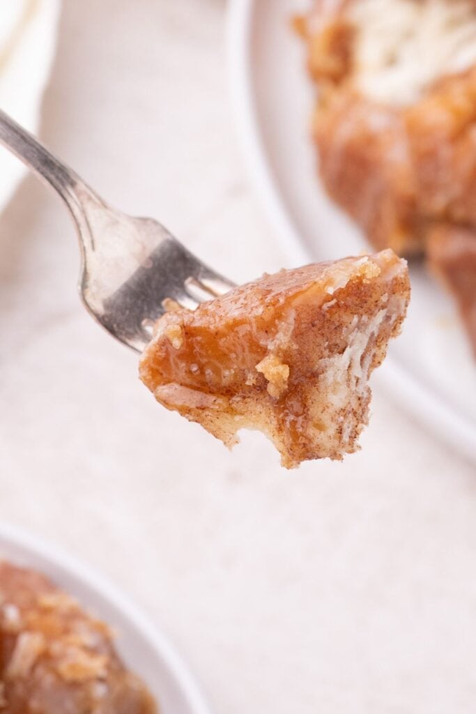 Fork with a bite of monkey bread on it.