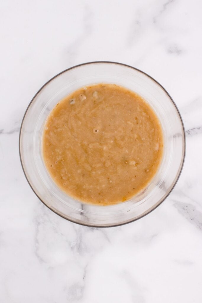 Gravy in a glass bowl for round steak recipe.