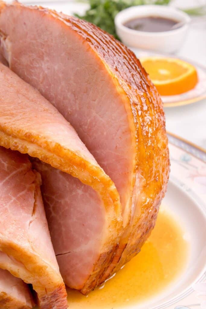 Close up of spiral ham on a serving plate.