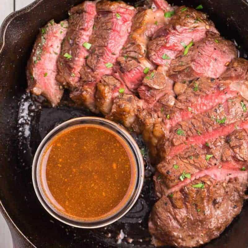 sliced steak in a cast iron skillet