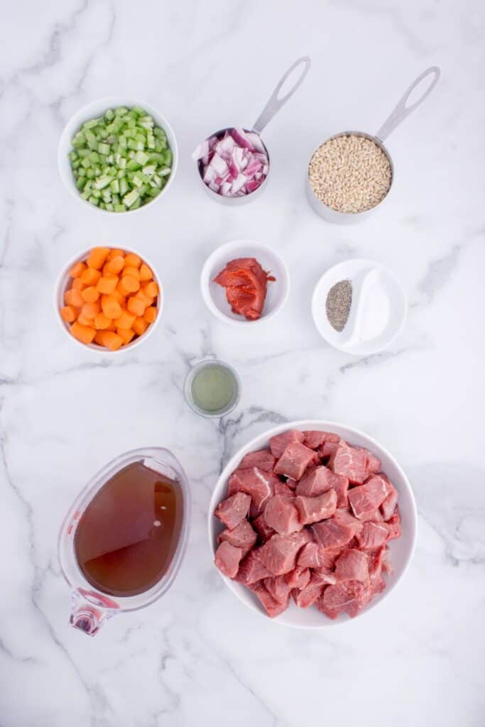 Ingredients for Beef and Barley Soup: Chuck roast, onion, carrots, celery, tomato paste, beef stock, pearl barley, olive oil, and salt and pepper.