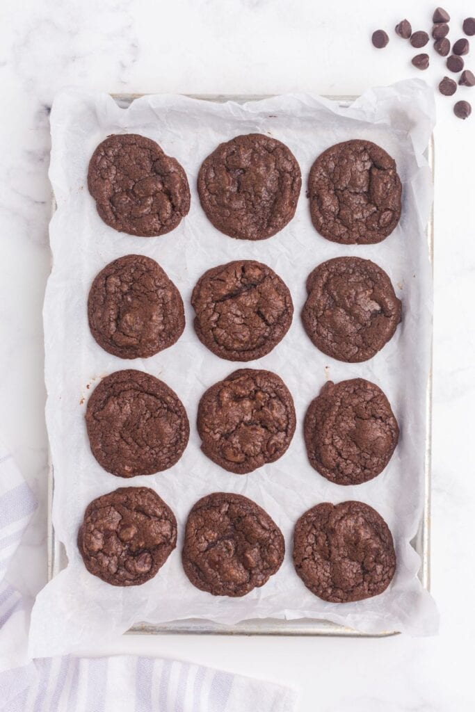 Baked cookies on a parchment lined baking sheet.