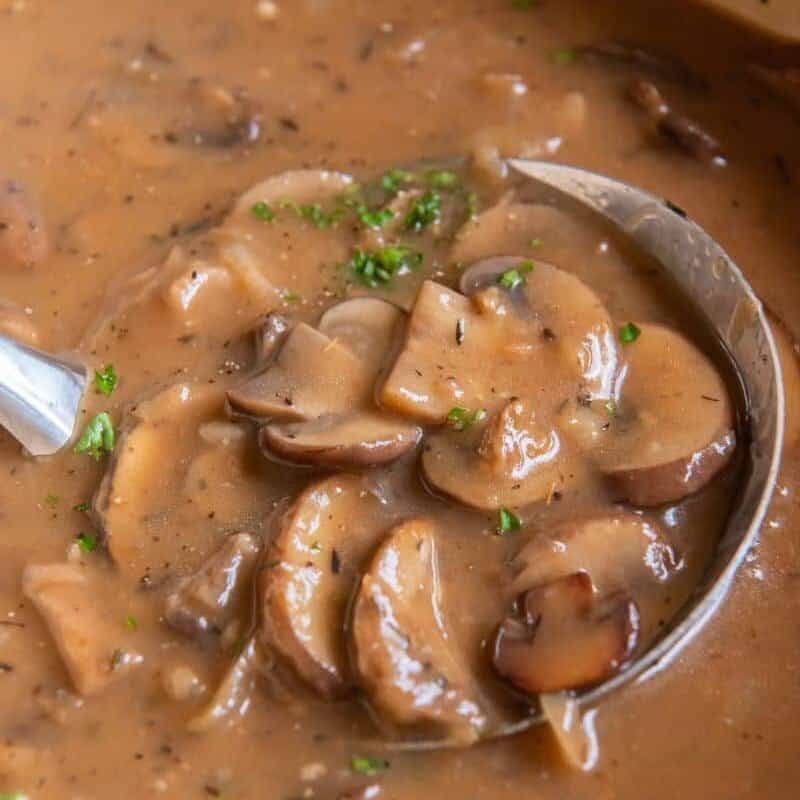 mushroom gravy in a ladel