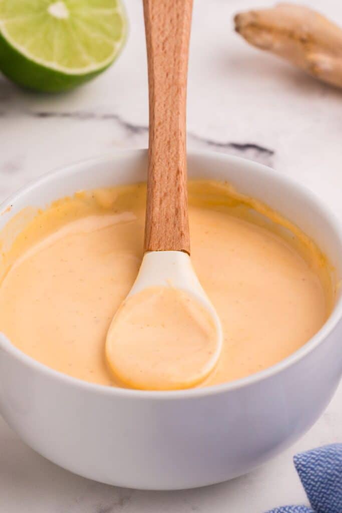 Bowl of spicy mayo with a small spatula.