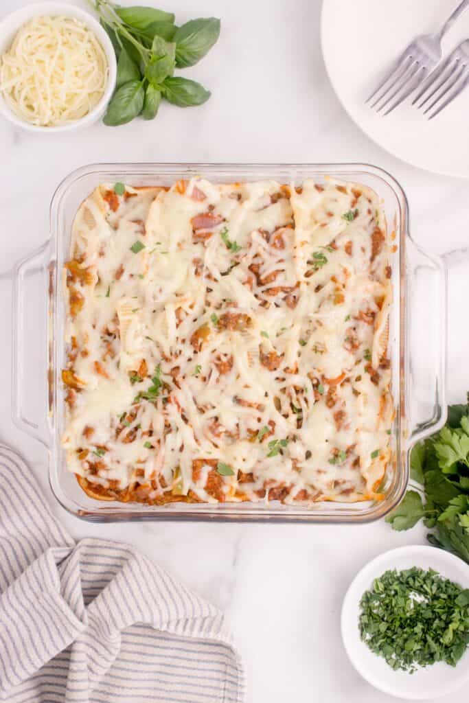 Overhead view of beef stuffed shells in a glass casserole dish.