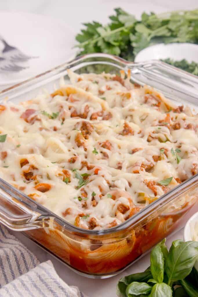 Completed beef stuffed shells recipe in a glass casserole dish.