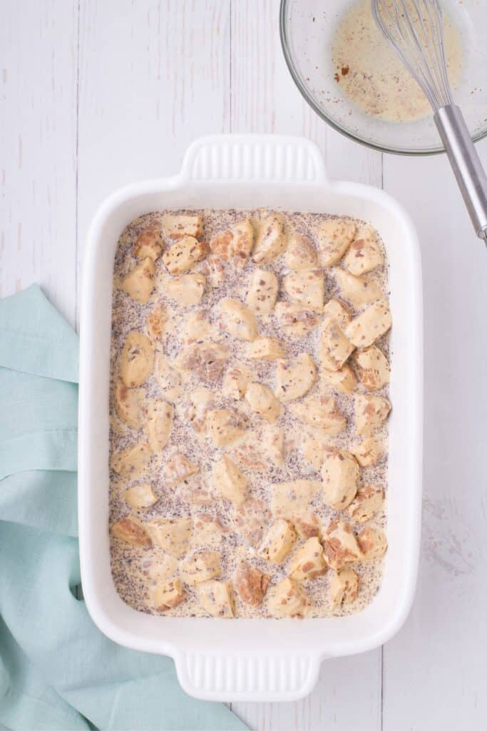 Unbaked prepped casserole in a white baking dish.