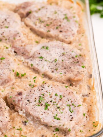 Close up view of pork chop casserole in the glass baking dish.