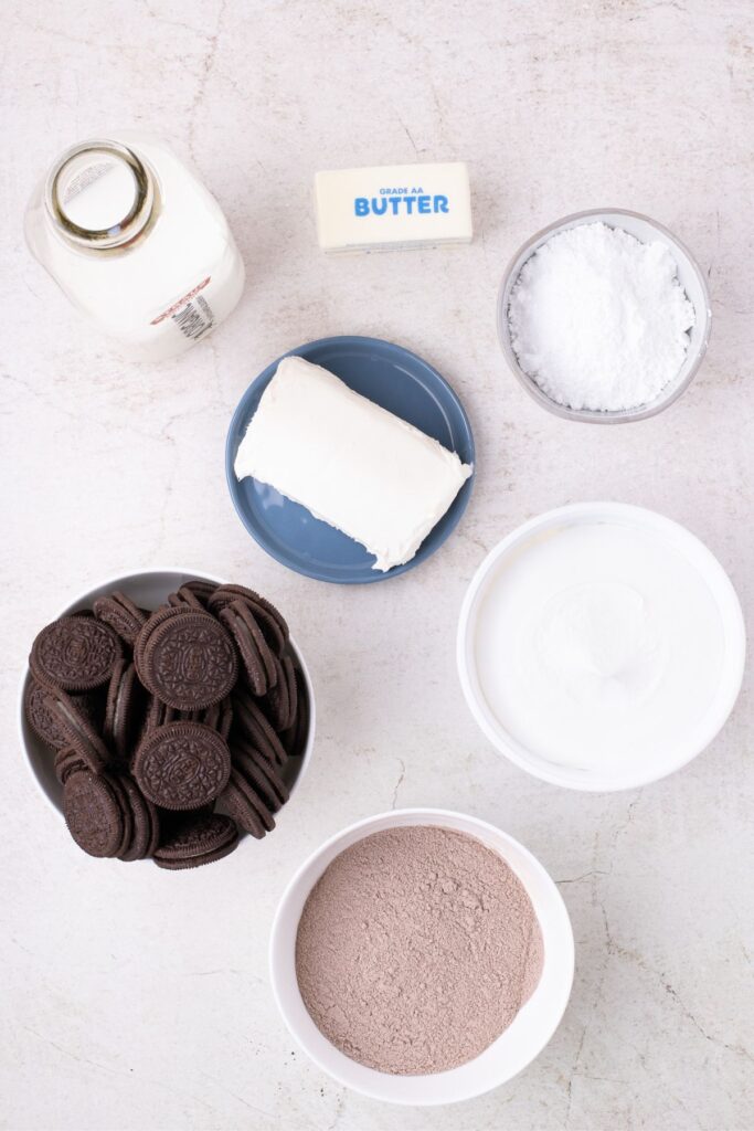 Ingredients for dirt cake: Oreos, chocolate pudding mix, milk, butter, cream cheese, powdered sugar, and Cool Whip.