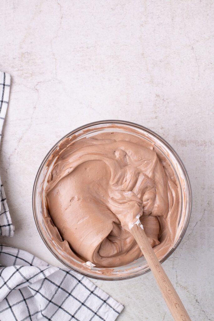 Whipped center of dirt cake in a glass mixing bowl.