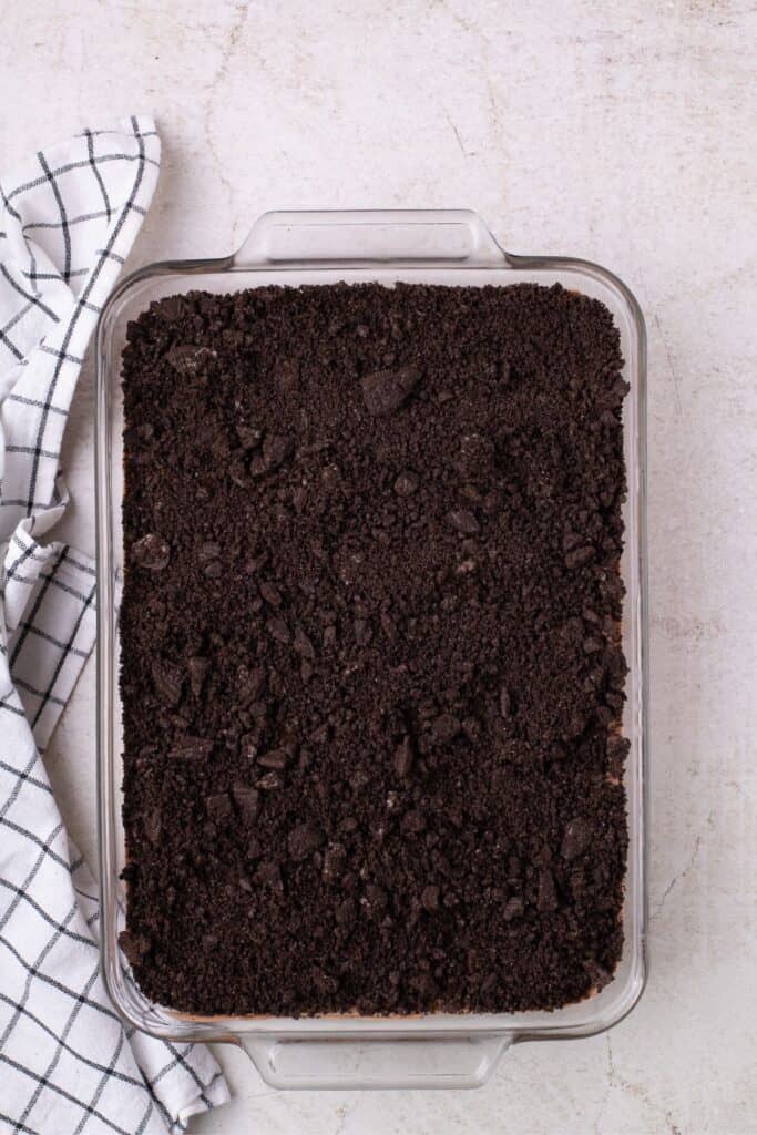 Overhead view of completed dirt cake in a glass baking dish.