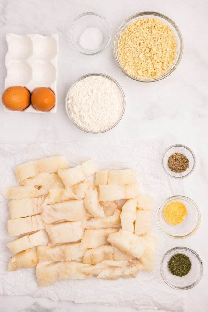 Ingredients for air fryer fish sticks: Cod, flour, salt, pepper, garlic powder, dried dill, eggs, and panko bread crumbs.