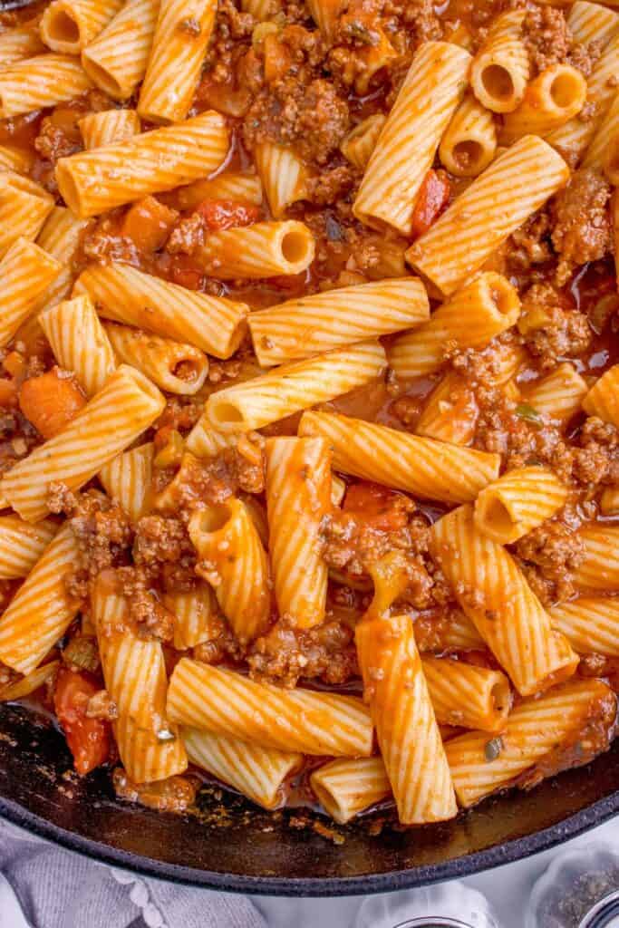 Close up of pasta bolognese in a large skillet.