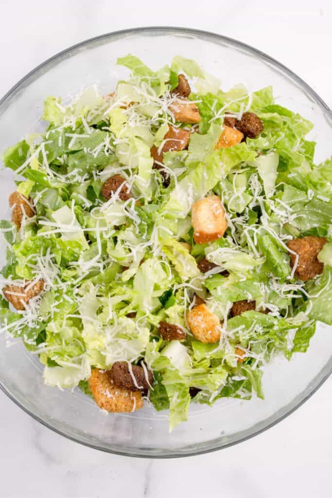 Caesar salad in a bowl right before adding the chicken on top.