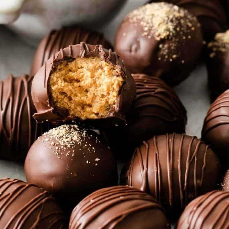 Pile of peanut butter balls and the top one has a bite taken out of it