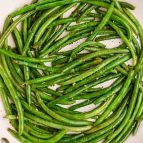 Cooked garlic green beans in a skillet.