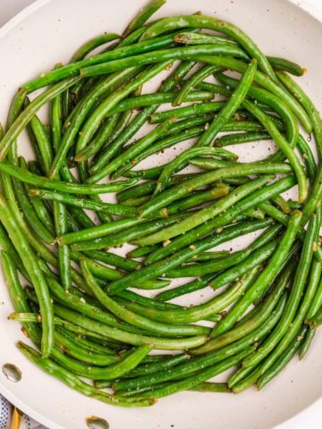 Cooked garlic green beans in a skillet.