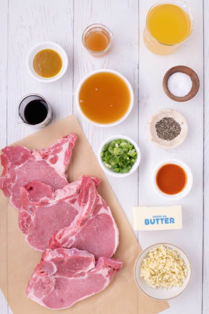 Ingredients for honey garlic pork chops: Pork loin rib chops, salt, black pepper, butter, garlic, chicken broth, Better Than Bouillon, honey, soy sauce, apple cider vinegar, hot sauce, and green onions.