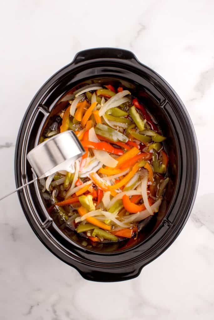 Cornstarch slurry poured into crock pot to thicken the liquid.