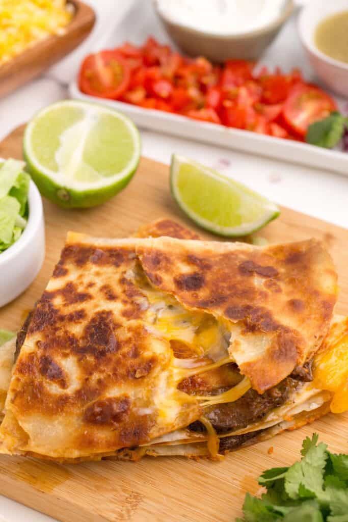 Quesadilla is pulled into two revealing steak and cheese inside.