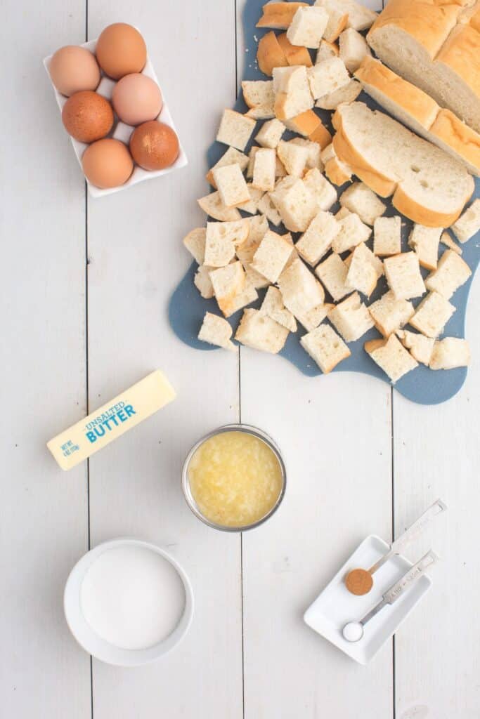 Ingredients for pineapple casserole: crushed pineapple, sliced bread, eggs, butter, sugar, salt, and cinnamon.