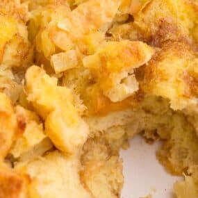 Close up of stuffing with a serving scooped out of the baking dish.