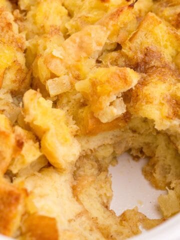 Close up of stuffing with a serving scooped out of the baking dish.