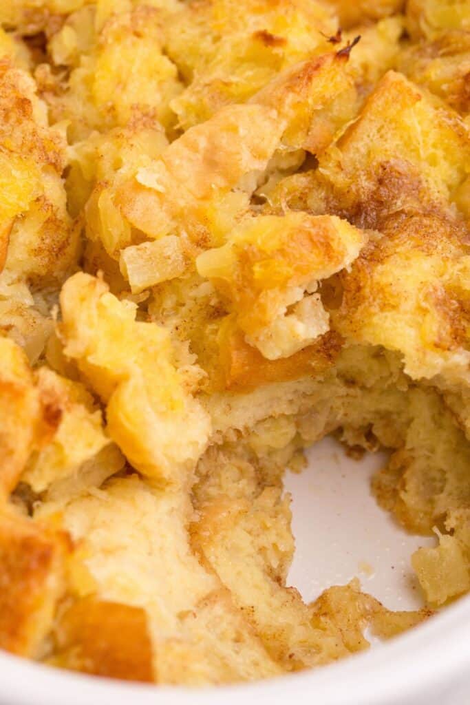 Close up of stuffing with a serving scooped out of the baking dish.